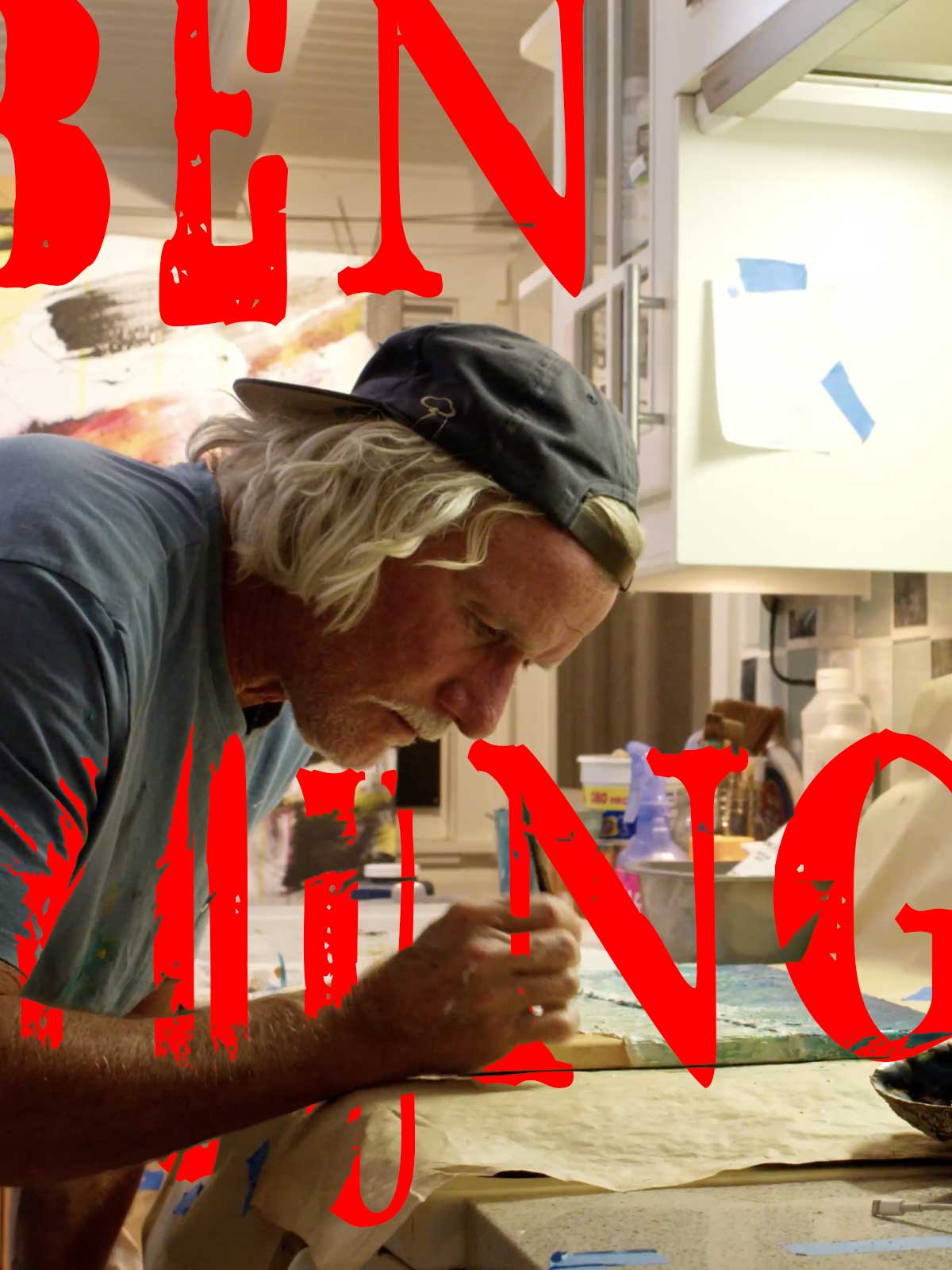 Photo of Ben young painting with red letters that spell Ben Young