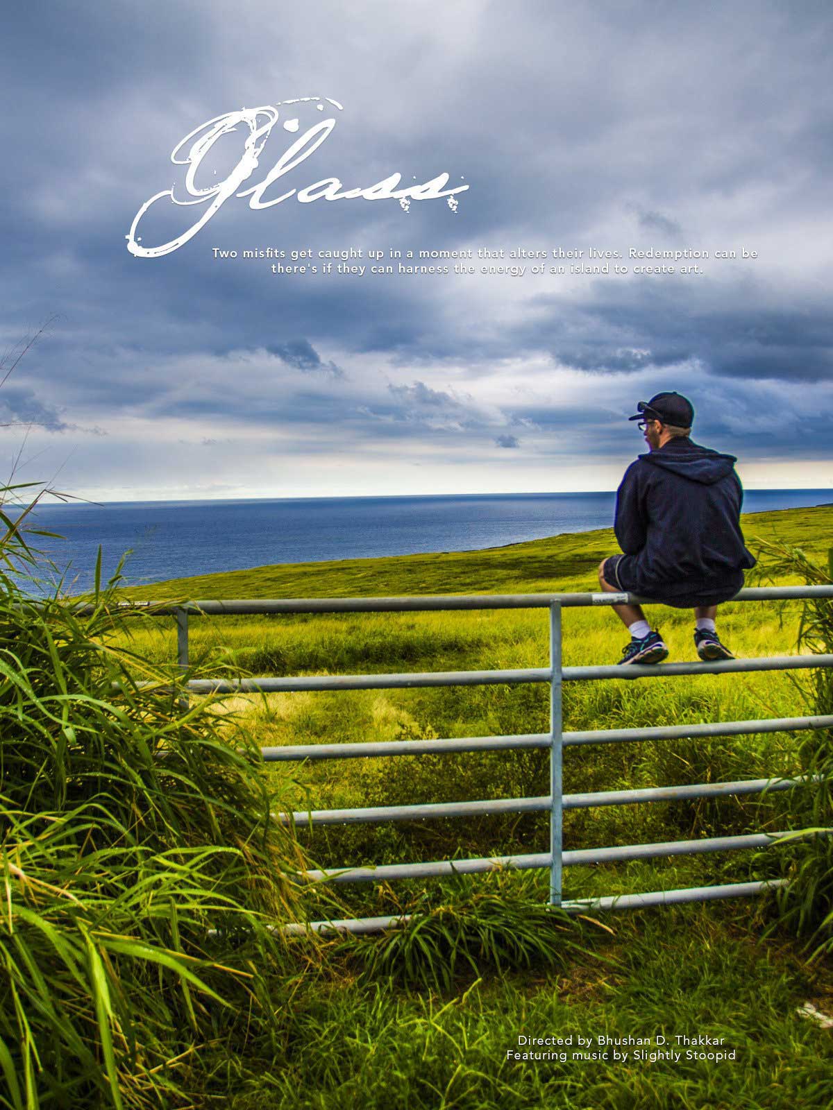 Glass Poster with a man sitting on a railing looking at ocean with text that says "glass, two misfits get cught up in a moment that alters their lives. redemption can be there's if they can harness the energy of an island to create art."