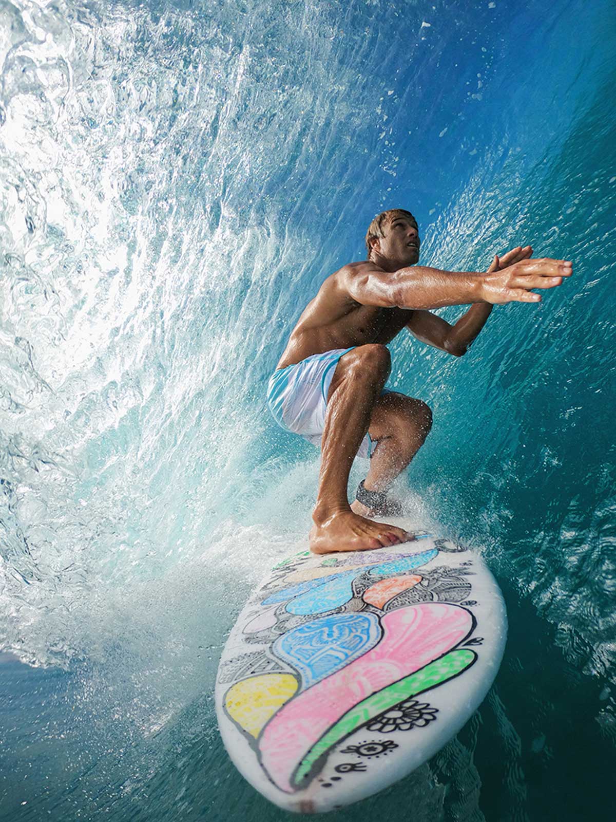 man surfing in a tube of a wave