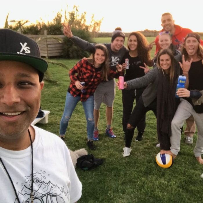 Man taking a selfie with talent and crew in the background