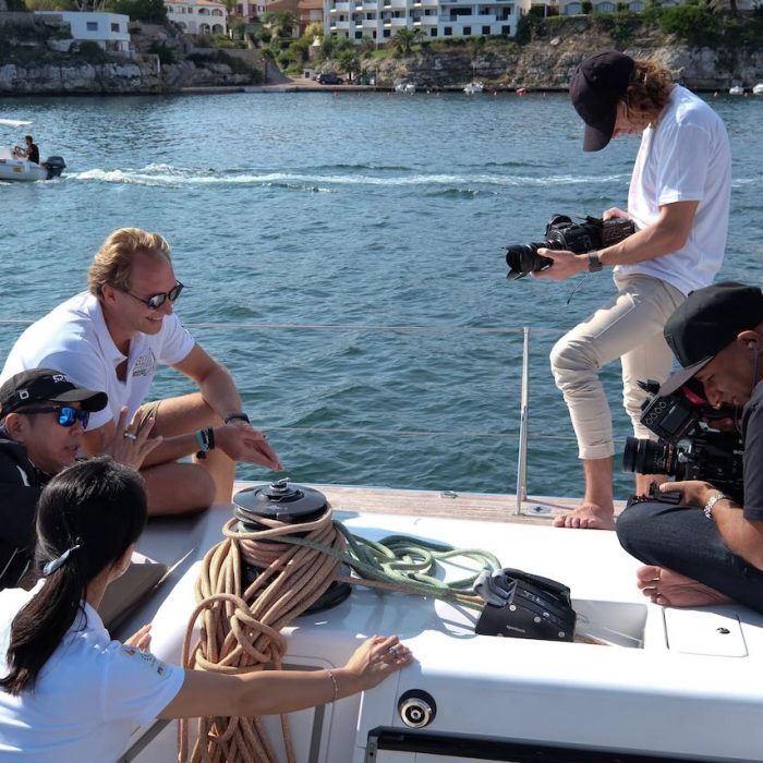 Shoot on a boat in spain with multiple actors two camera operators with boats in the background